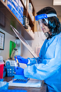 Phlebotomist wearing personal protective equiment at a DLO Patient Service Center